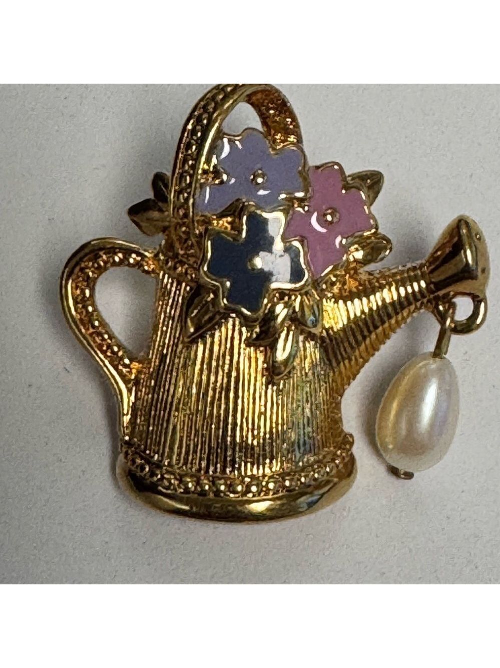 Vintage 1992 Avon "Friendship in Bloom" lapel pin. Gold tone watering can.